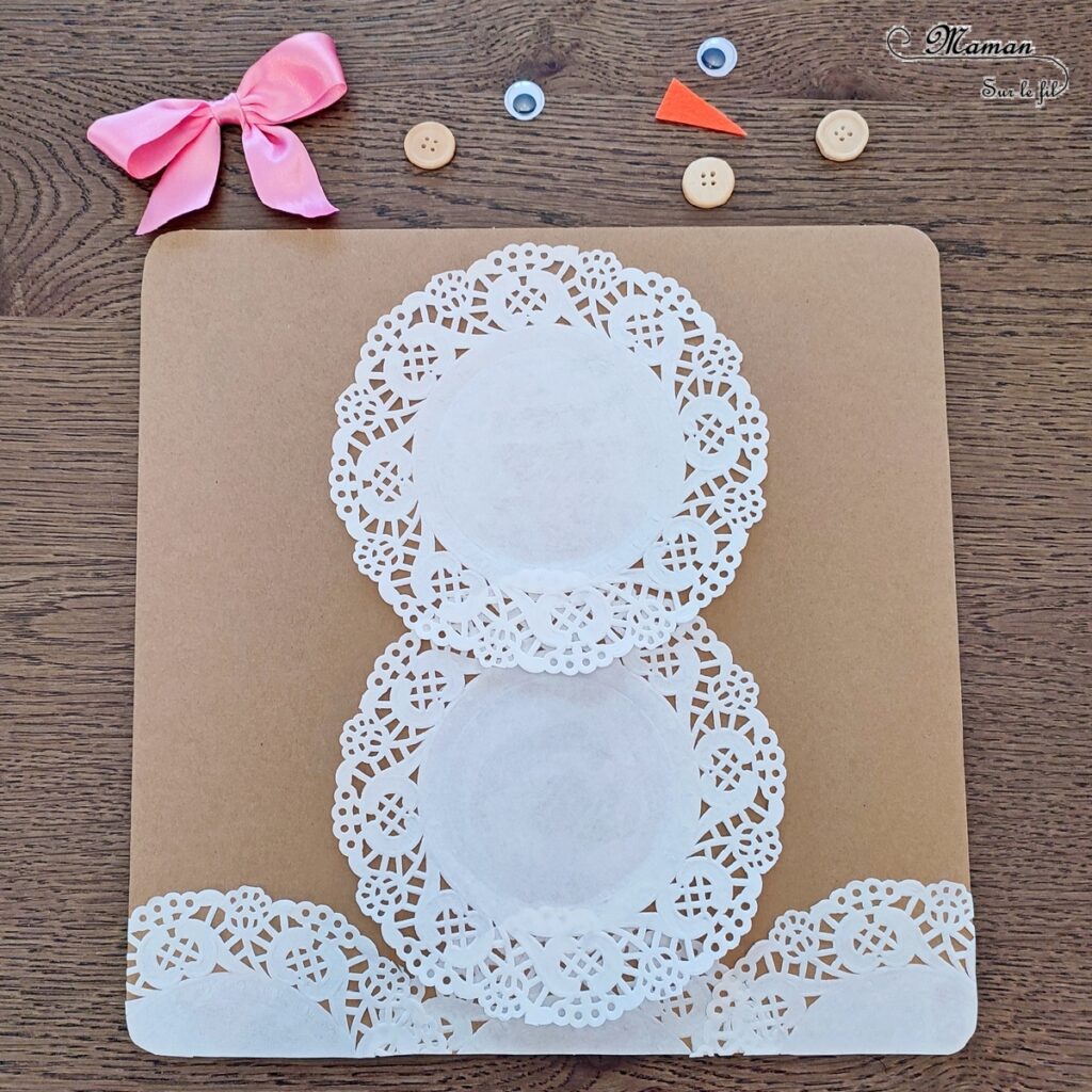 Créer un bonhomme de neige avec des napperons : activité créative, récup' et manuelle enfants - Recyclage de carton pour le fond, napperons pour le bonhomme de neige et le sol, accessoires (boutons en bois, noeud en ruban,, feutrine, yeux mobiles - découpage, collage, dessin - Bricolage sympa pour une décoration hivernale - récup' et Surcyclage - Arts visuels et Bricolage - Thème hiver, neige - Bricolage facile et rapide - Arts visuels et atelier Maternelle et élémentaire - Créativité - Cycle 1 ou 2 - tutoriel photos - mslf