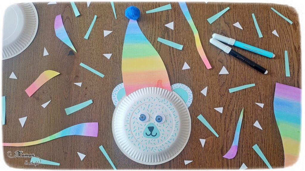 Fabriquer un ours polaire et son bonnet arc-en-ciel (avec une assiette en carton) : activité créative, récup' et manuelle enfants - Peinture, couleurs de l'arc-en-ciel, découpage, collage de papier - Pompon, yeux mobiles, dessin et graphismes - Bricolage sympa pour une décoration hivernale - Surcyclage - Arts visuels et Bricolage - Thème hiver, animaux de la banquise et du froid - Bricolage facile et rapide - Arts visuels et atelier Maternelle et élémentaire - Créativité - Cycle 1 ou 2 - tutoriel photos - mslf