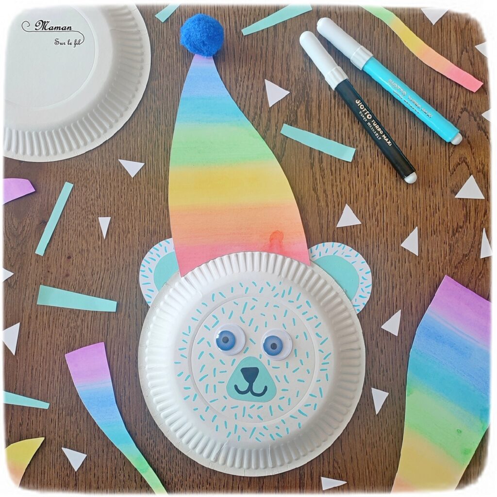 Fabriquer un ours polaire et son bonnet arc-en-ciel (avec une assiette en carton) : activité créative, récup' et manuelle enfants - Peinture, couleurs de l'arc-en-ciel, découpage, collage de papier - Pompon, yeux mobiles, dessin et graphismes - Bricolage sympa pour une décoration hivernale - Surcyclage - Arts visuels et Bricolage - Thème hiver, animaux de la banquise et du froid - Bricolage facile et rapide - Arts visuels et atelier Maternelle et élémentaire - Créativité - Cycle 1 ou 2 - tutoriel photos - mslf