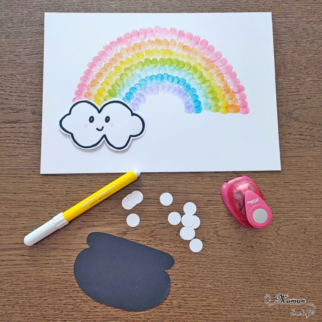 Créer un arc-en-ciel de la Saint-Patrick en empreintes de doigts : activité créative et manuelle enfants - Empreintes de doigts faites avec de l'encre pour tampons - 3 formes de coeur à la perforatrice pour créer les trèfles - Découpage, collage - Dessin et écriture - Chaudron, trésor, pièces, nuages - Arts visuels et Bricolage - Thème Trèfles, Saint-Patrick, Irlande, Géographie, autour du monde - Découverte d'un pays - Bricolage facile et rapide - Arts visuels et atelier Maternelle et élémentaire - Créativité - Cycle 1 ou 2 - tutoriel photos - mslf