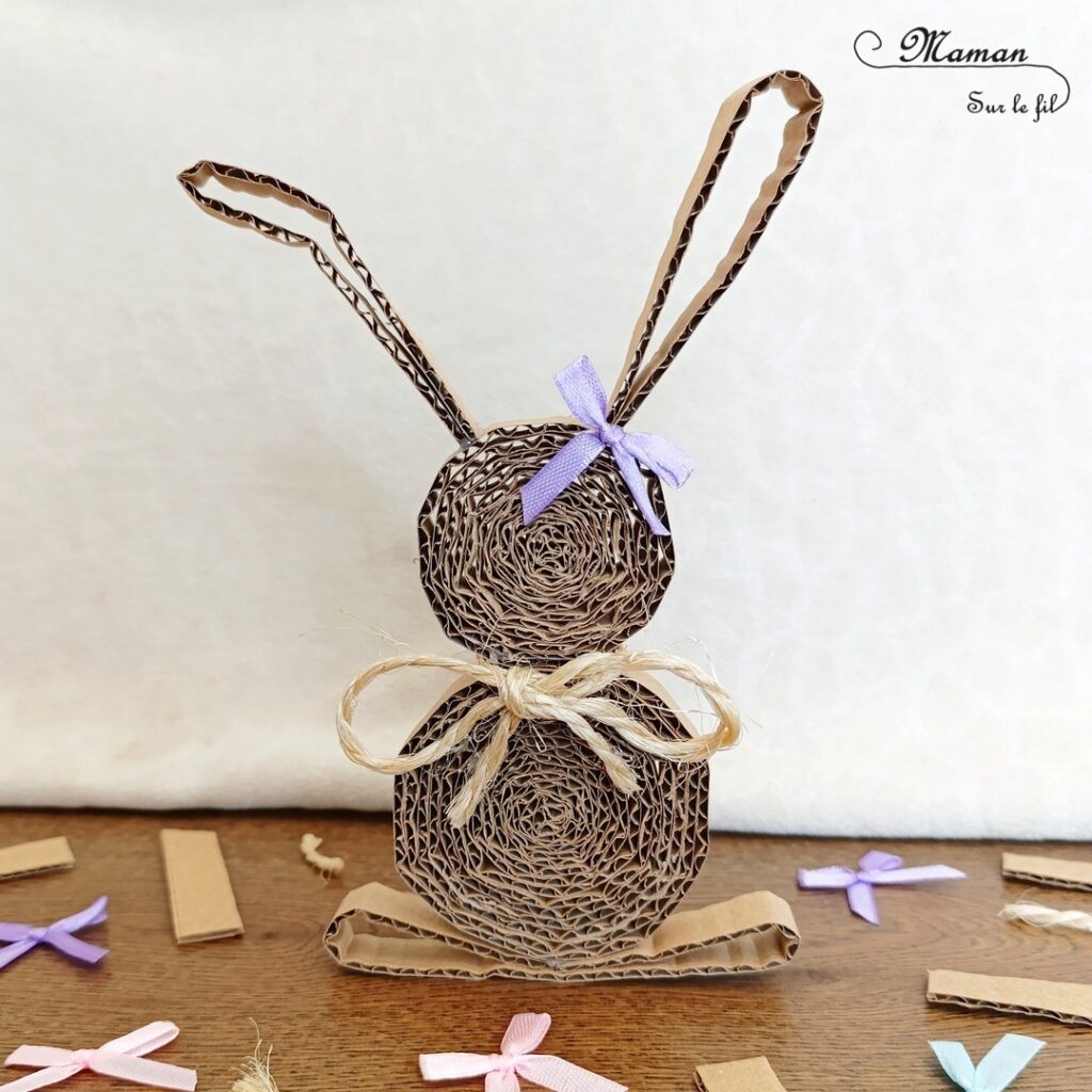 Fabriquer un lapin en carton enroulé : activité créative, récup' et manuelle enfants - Bricolage et décoration DIY simples pour Pâques - Recyclage, surcyclage de carton - Technique du carton enroulé pour des cercles en 3D - Noeud autour du cou en cordelette et petit noeud violet à l'oreille - Fait maison - Thème Pâques, animaux de la ferme, de la forêt - Bricolage et décoration sympa et facile - Arts visuels maternelle et élémentaire - Cycles 1 et 2 - Créativité - tutoriel photos - mslf