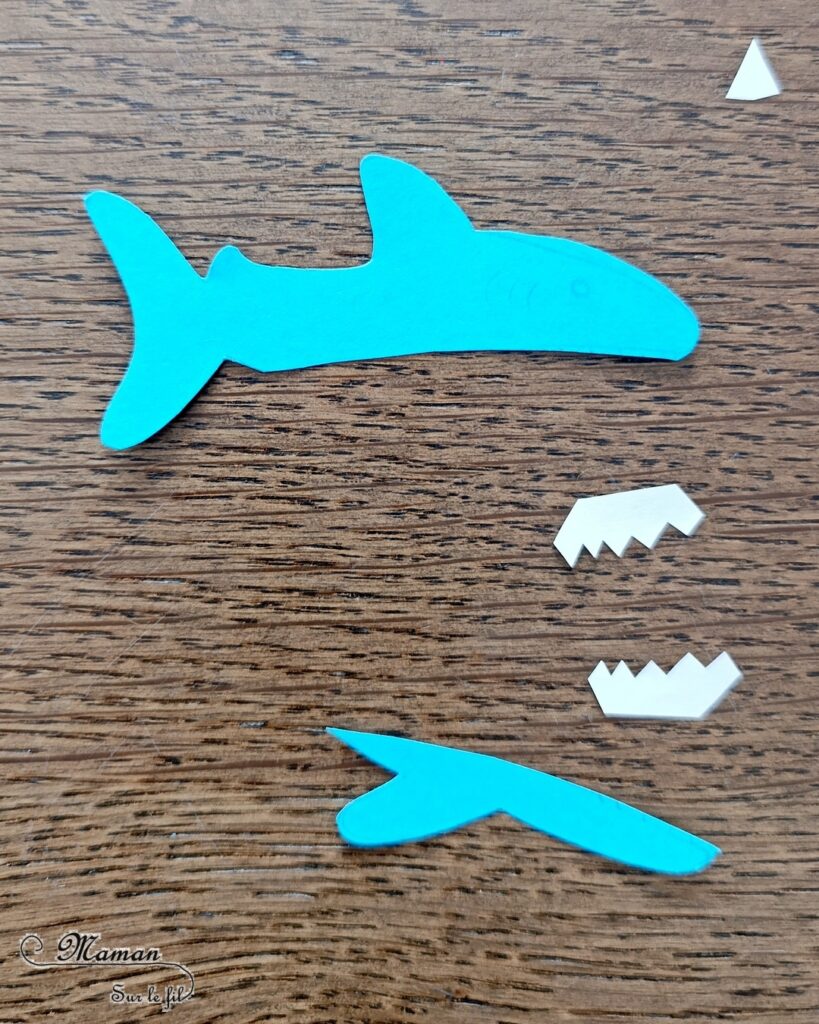 Fabriquer un requin Pince à linge et son petit poisson caché dans sa bouche : activité créative, rigolote et manuelle enfants - Découpage, collage, dessin - Pince à linge pour ouvrir la bouche du requin et faire apparaître un petit poisson - Muscler les petits doigts, motricité fine - Bricolage facile et rigolo - Thème animaux marins, océans, mer, été - Bricolage et décoration sympa et facile - Arts visuels maternelle et élémentaire - Cycles 1 et 2 - Créativité - tutoriel photos et vidéo - mslf