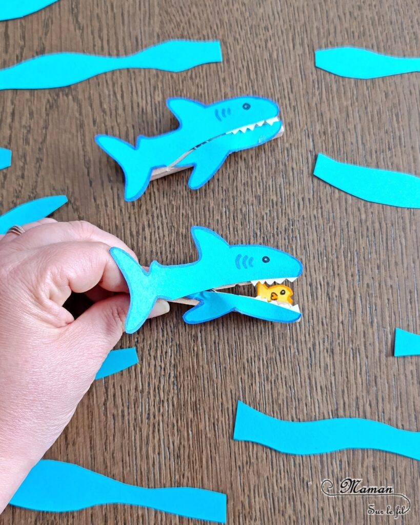 Fabriquer un requin Pince à linge et son petit poisson caché dans sa bouche : activité créative, rigolote et manuelle enfants - Découpage, collage, dessin - Pince à linge pour ouvrir la bouche du requin et faire apparaître un petit poisson - Muscler les petits doigts, motricité fine - Bricolage facile et rigolo - Thème animaux marins, océans, mer, été - Bricolage et décoration sympa et facile - Arts visuels maternelle et élémentaire - Cycles 1 et 2 - Créativité - tutoriel photos et vidéo - mslf