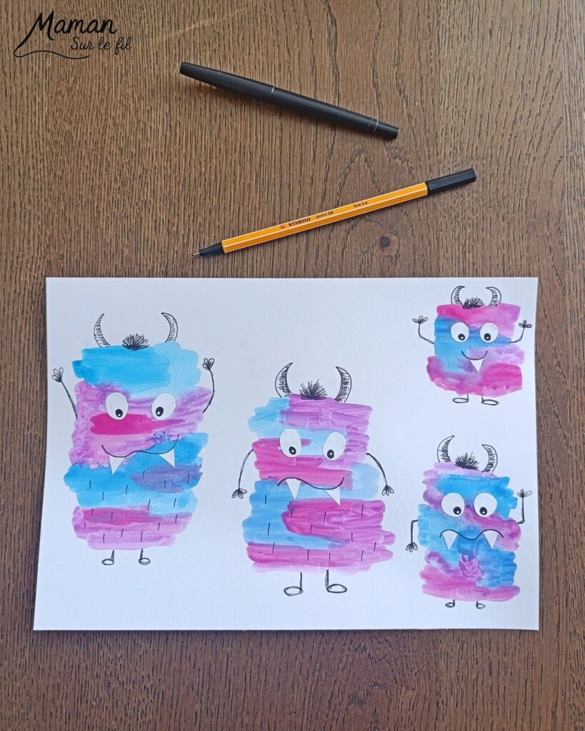 Peindre une famille de petits monstres mignons et colorés : activité créative, peinture et manuelle enfants - Peinture façon aquarelle - Bandes gribouillées - Couleurs bleu, rose et violet - Dessin des détails en noir pour le contraste - Découpage et collage des yeux et dents pour un air rigolo - Bricolage et décoration DIY et facile - Bricolage Fait maison, décoration - Thème Halloween, créatures imaginaires, monstres - Bricolage sympa et facile - Arts visuels Maternelle et cycle 2 - Maternelle et élémentaire - Créativité - Cycle 1 ou 2 - tutoriel photos - mslf