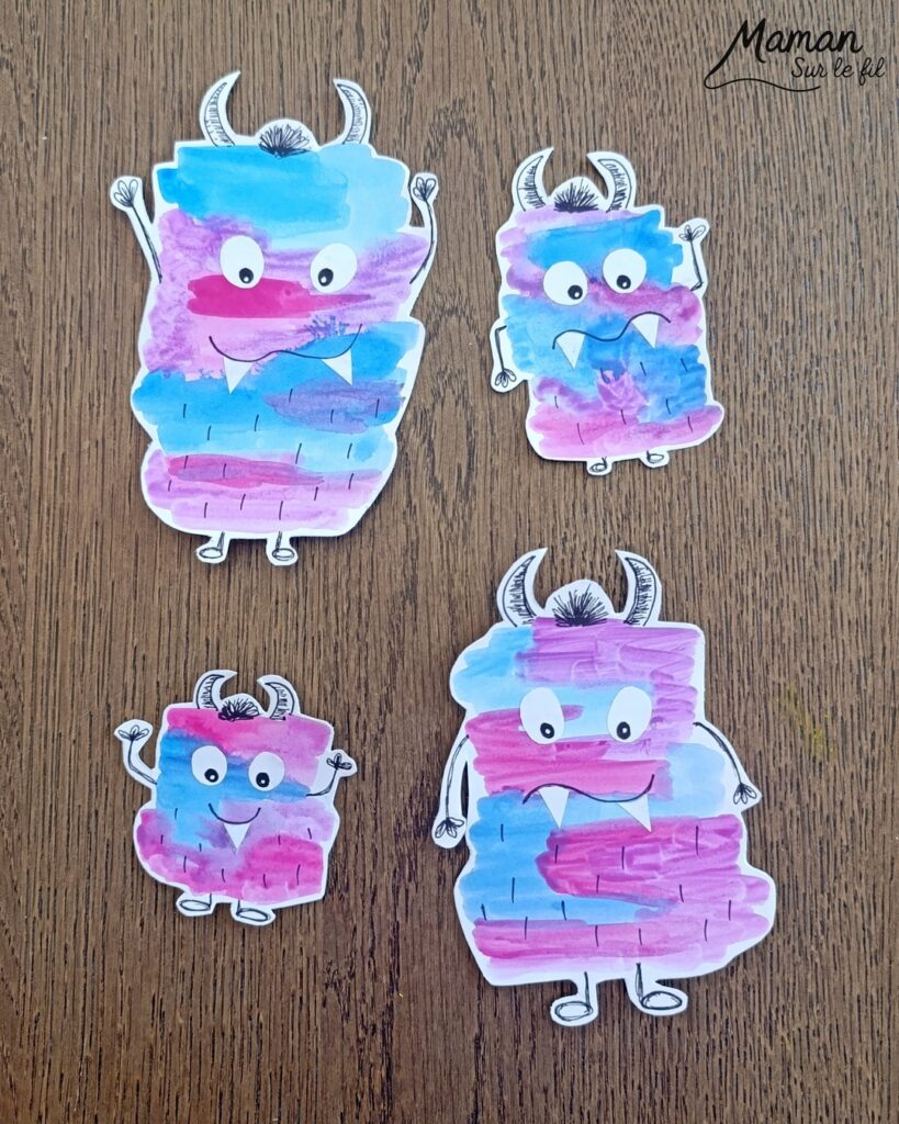 Peindre une famille de petits monstres mignons et colorés : activité créative, peinture et manuelle enfants - Peinture façon aquarelle - Bandes gribouillées - Couleurs bleu, rose et violet - Dessin des détails en noir pour le contraste - Découpage et collage des yeux et dents pour un air rigolo - Bricolage et décoration DIY et facile - Bricolage Fait maison, décoration - Thème Halloween, créatures imaginaires, monstres - Bricolage sympa et facile - Arts visuels Maternelle et cycle 2 - Maternelle et élémentaire - Créativité - Cycle 1 ou 2 - tutoriel photos - mslf