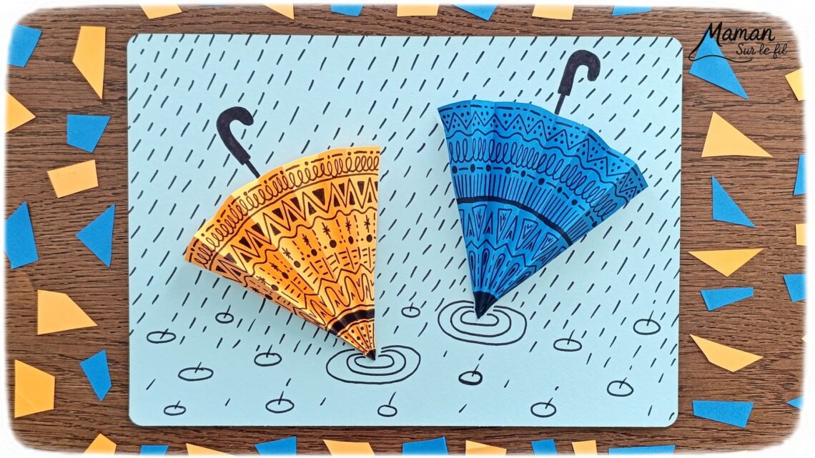 Créer des parapluies graphiques en volume : activité créative, papier et manuelle enfants - Dessin de cercles au compas - Graphismes et dessins noirs pour les décors du parapluie - Découpage et pliage pour l'accordéon - Collage et dessins pour donner l'impression que les parapluies sont posés sous la pluie - Traits obliques - Bricolage et décoration DIY et facile - Bricolage Fait maison, décoration - Thème Météo, Pluie, Nuage, Ciel, Automne - Bricolage sympa et facile - Arts visuels Maternelle et cycle 2 - Maternelle et élémentaire - Créativité - Cycle 1 ou 2 - tutoriel photos - mslf