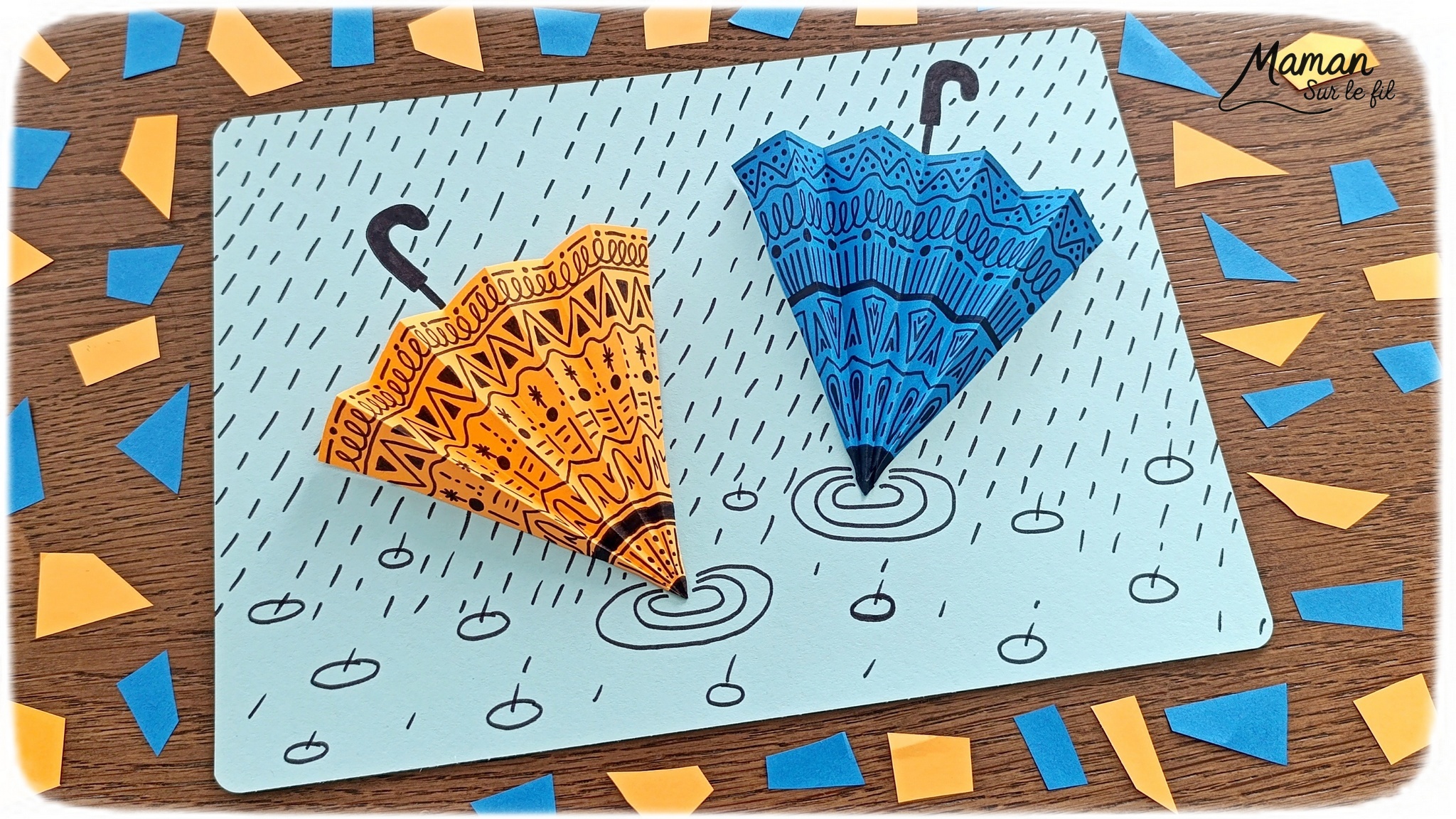 Créer des parapluies graphiques en volume : activité créative, papier et manuelle enfants - Dessin de cercles au compas - Graphismes et dessins noirs pour les décors du parapluie - Découpage et pliage pour l'accordéon - Collage et dessins pour donner l'impression que les parapluies sont posés sous la pluie - Traits obliques - Bricolage et décoration DIY et facile - Bricolage Fait maison, décoration - Thème Météo, Pluie, Nuage, Ciel, Automne - Bricolage sympa et facile - Arts visuels Maternelle et cycle 2 - Maternelle et élémentaire - Créativité - Cycle 1 ou 2 - tutoriel photos - mslf