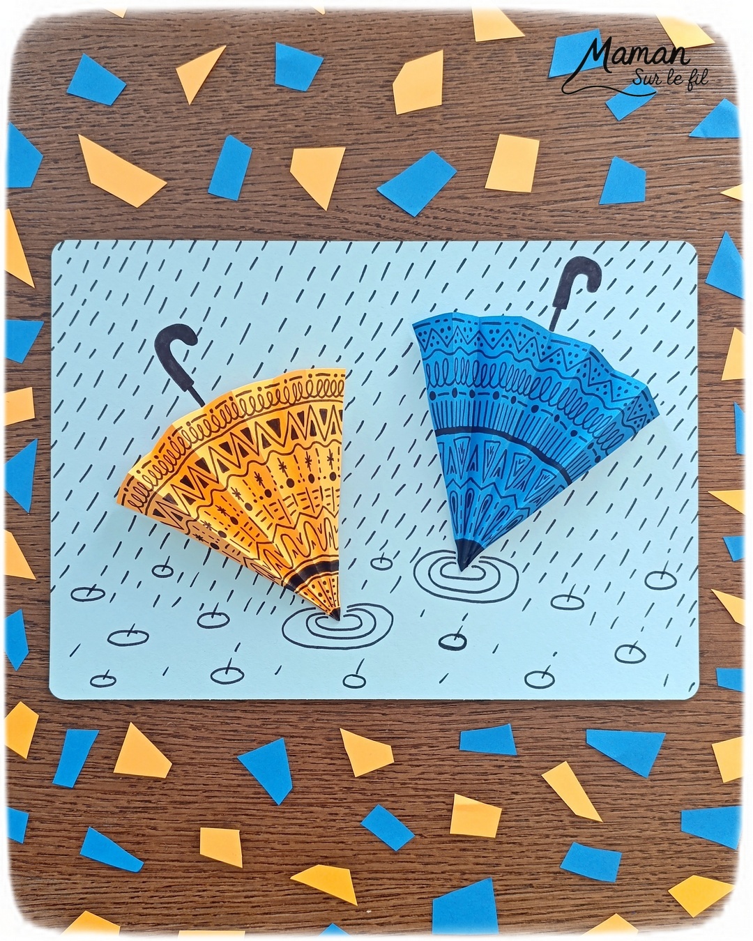 Créer des parapluies graphiques en volume : activité créative, papier et manuelle enfants - Dessin de cercles au compas - Graphismes et dessins noirs pour les décors du parapluie - Découpage et pliage pour l'accordéon - Collage et dessins pour donner l'impression que les parapluies sont posés sous la pluie - Traits obliques - Bricolage et décoration DIY et facile - Bricolage Fait maison, décoration - Thème Météo, Pluie, Nuage, Ciel, Automne - Bricolage sympa et facile - Arts visuels Maternelle et cycle 2 - Maternelle et élémentaire - Créativité - Cycle 1 ou 2 - tutoriel photos - mslf