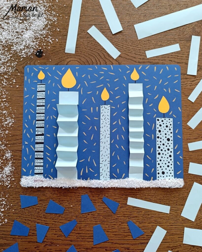 Créer une carte avec des bougies hivernales en papier, pliées en accordéon et décorées de graphismes : activité créative et manuelle enfants - Découpage, pliage et collage de papier - Pliage en accordéon - Dessins et graphismes noirs - Contraste avec couleurs hivernales - Sur lit de fausse neige - Bricolage joli et décoration DIY et facile - Bricolage Fait maison, décoration - Thème Noël, fêtes de fin d'année, cartes de voeux, hiver, cocooning - Bricolage sympa et facile - Arts visuels Maternelle et cycle 2 - Maternelle et élémentaire - Créativité - Cycle 1 ou 2 - tutoriel photos - mslf