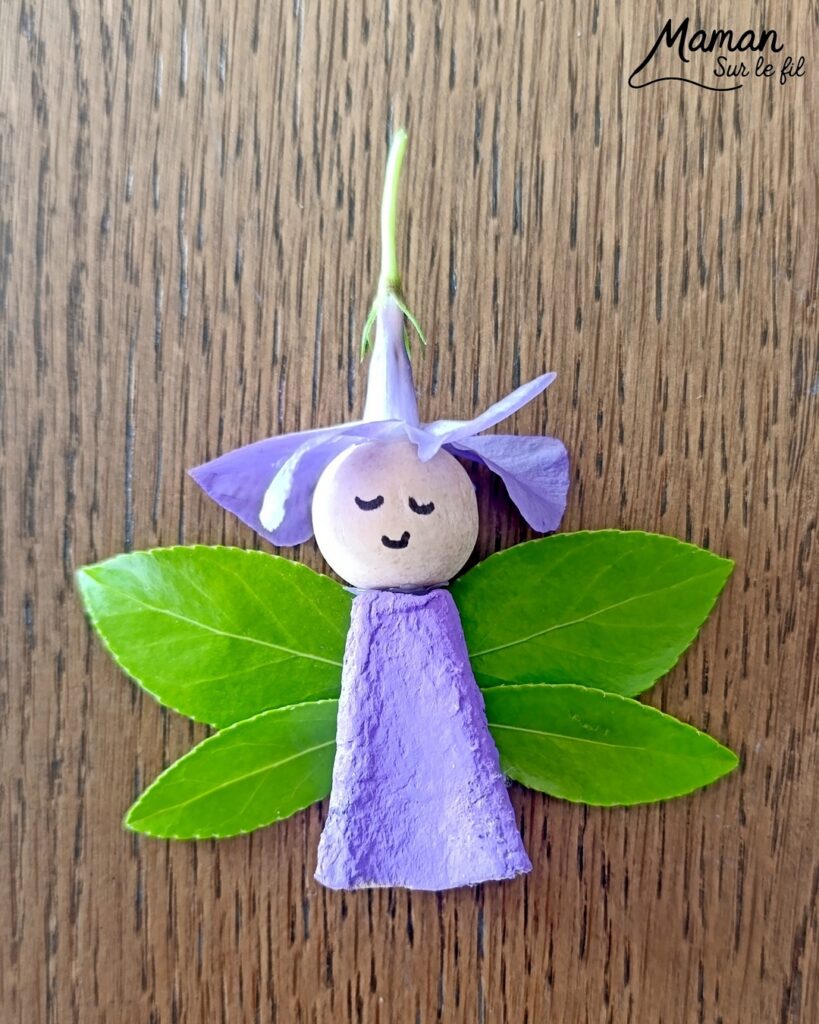 Créer une fée Nature du printemps : activité créative, récup', peinture, nature et manuelle enfants - Recyclage, surcyclage de boites à oeufs - Découper et peindre un pic en carton - Ailes avec des feuilles vertes - Tête avec perle en bois - Cheveux et chapeau avec fleur violette - Utiliser les trésors du printemps - Land Art, atelier nature, école dehors - Décoration éphémère DIY Fait maison - Cadeau DIY, fait maison à offrir - Bricolage facile et rapide - Thème fleurs, nature, printemps, personnages imaginaires et féériques - Bricolage et décoration sympa et facile - Arts visuels maternelle et élémentaire - Cycles 1 et 2 - Créativité - tutoriel photos - mslf