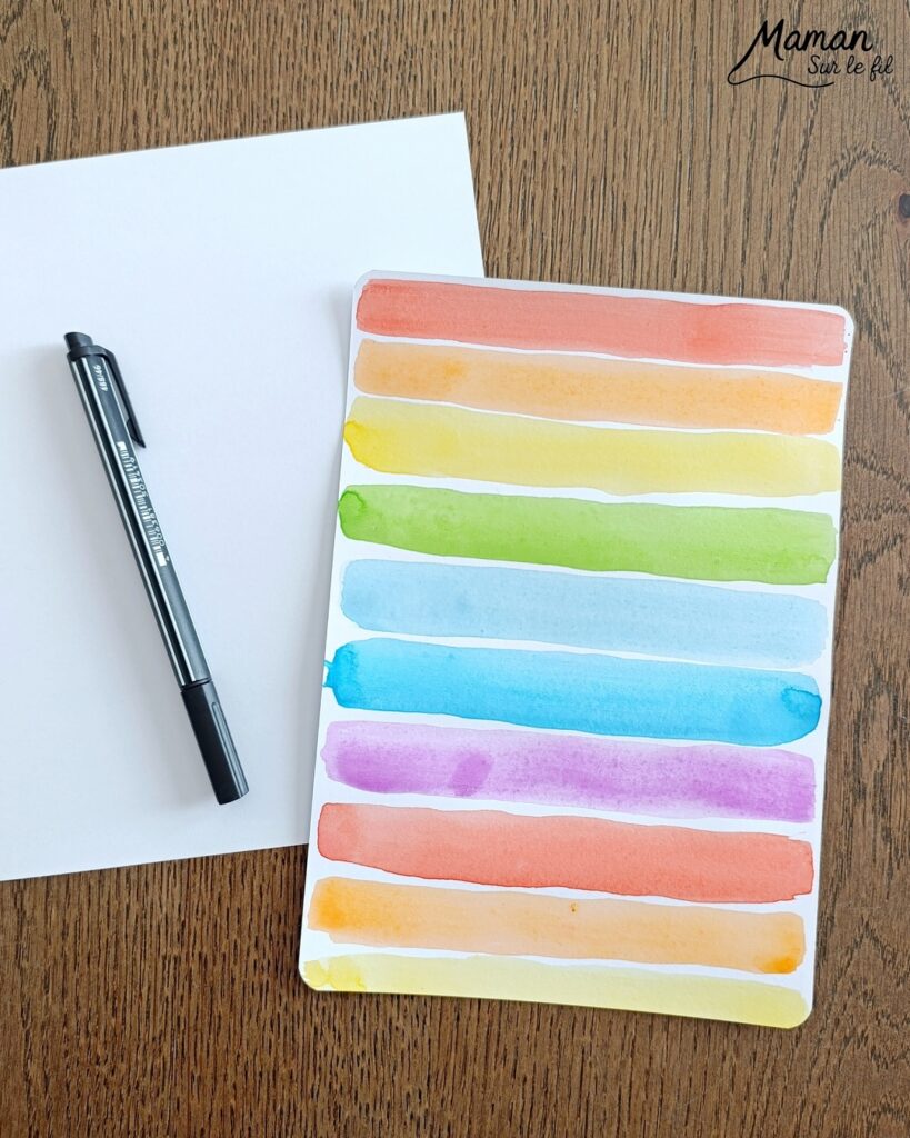 Créer une fleur en noir et blanc sur fond coloré Arc-en-ciel : activité créative, peinture et manuelle enfants - Peinture type aquarelle - Tracé de lignes horizontales aux couleurs de l'arc-en-ciel - Dessin de la fleur au feutre noir - Découpage, collage, contraste - Cadeau DIY, fait maison à offrir - Bricolage facile - Thème fleurs, nature, printemps - Bricolage et décoration sympa et facile - Arts visuels maternelle et élémentaire - Cycles 1 et 2 - Créativité - tutoriel photos - mslf