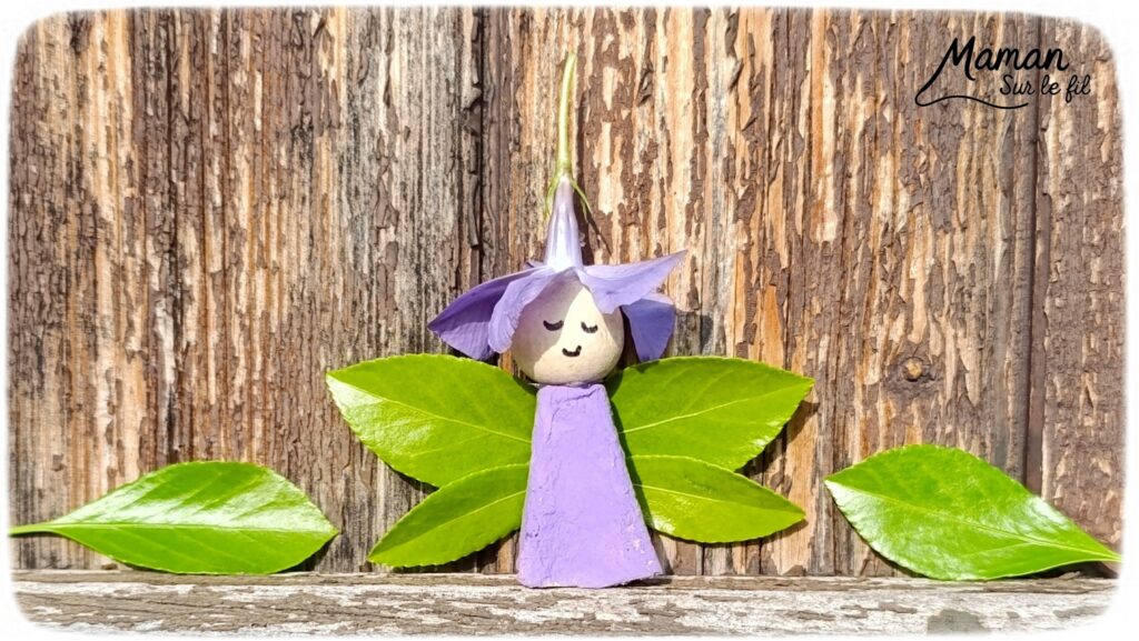 Créer une fée Nature du printemps : activité créative, récup', peinture, nature et manuelle enfants - Recyclage, surcyclage de boites à oeufs - Découper et peindre un pic en carton - Ailes avec des feuilles vertes - Tête avec perle en bois - Cheveux et chapeau avec fleur violette - Utiliser les trésors du printemps - Land Art, atelier nature, école dehors - Décoration éphémère DIY Fait maison - Cadeau DIY, fait maison à offrir - Bricolage facile et rapide - Thème fleurs, nature, printemps, personnages imaginaires et féériques - Bricolage et décoration sympa et facile - Arts visuels maternelle et élémentaire - Cycles 1 et 2 - Créativité - tutoriel photos - mslf