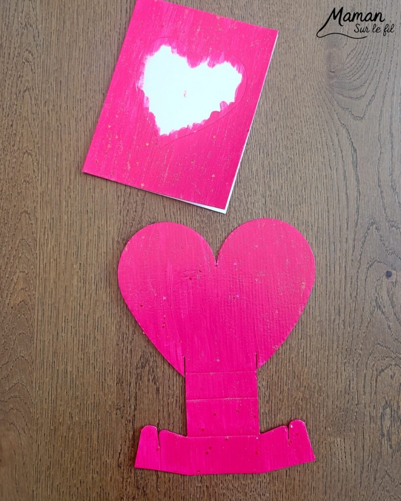 Fabriquer une carte et un support de téléphone en carton pour la fête des mères : activité créative, peinture, dessins et manuelle enfants - Matériel et supports en carton de chez Cléopâtre - Idée Cadeau à petit prix - Peinture rose, empreintes de doigts pour les coeurs, paillettes avec gel pailleté plein d'amour - Décor avec pompons blanc et message blanc et noir - Cadeau à offrir DIY Fait maison - Décoration DIY Fait maison - Arts visuels et Bricolage facile - Thème amour, amitié, Saint Valentin, fête des mères, grands-mères, pères, grands-pères - Bricolage et décoration sympa et facile - Arts visuels maternelle et élémentaire - Cycles 1 et 2 - Créativité - tutoriel photos - mslf