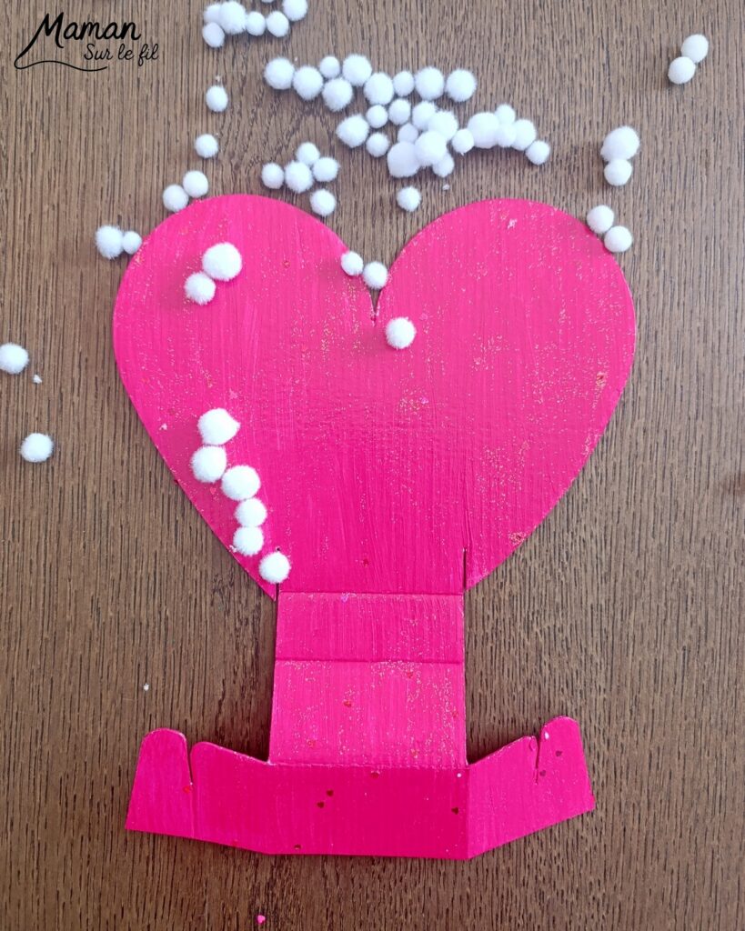 Fabriquer une carte et un support de téléphone en carton pour la fête des mères : activité créative, peinture, dessins et manuelle enfants - Matériel et supports en carton de chez Cléopâtre - Idée Cadeau à petit prix - Peinture rose, empreintes de doigts pour les coeurs, paillettes avec gel pailleté plein d'amour - Décor avec pompons blanc et message blanc et noir - Cadeau à offrir DIY Fait maison - Décoration DIY Fait maison - Arts visuels et Bricolage facile - Thème amour, amitié, Saint Valentin, fête des mères, grands-mères, pères, grands-pères - Bricolage et décoration sympa et facile - Arts visuels maternelle et élémentaire - Cycles 1 et 2 - Créativité - tutoriel photos - mslf