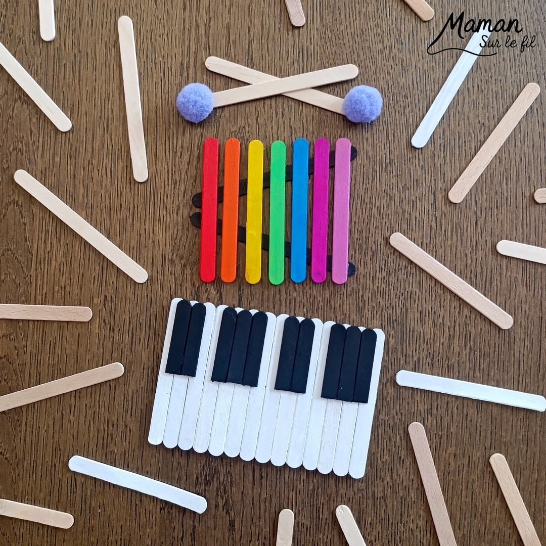 Fabriquer des instruments de musique avec des bâtonnets de glace en bois : activité créative, récup', peinture et manuelle enfants - Recyclage, surcyclage de bâtonnets de glace en bois - Gouache en stick aux couleurs de l'arc-en-ciel pour le xylophone - Pompons pour les baguettes - Noir et blanc pour le clavier de piano - Décoration DIY Fait maison - Arts visuels et Bricolage facile - Thème fête de la musique, instruments de musique, été - Bricolage et décoration sympa et facile - Arts visuels maternelle et élémentaire - Cycles 1 et 2 - Créativité - tutoriel photos - mslf