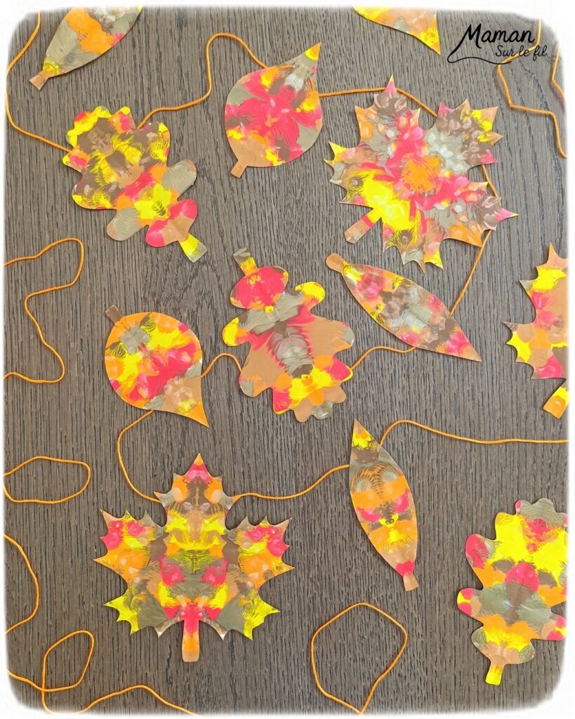 Créer une guirlande de feuilles mortes d'automne en peinture symétrique : activité créative, peinture et manuelle - Découpage des feuilles et peinture par symétrie en pliant le papier en deux - Technique de peinture pour aborder la symétrie - Couleurs chaudes et automnales - Scotchage à un fil ou à un bout de laine pour en faire une guirlande à suspendre, une suspension pour décorer - Bricolage et décoration DIY et facile - Bricolage Fait maison, décoration - Thème Forêts, Arbres, feuilles mortes, automne - Bricolage sympa et facile - Arts visuels Maternelle et cycle 2 - Maternelle et élémentaire - Créativité et lecture jeunesse - Cycle 1 ou 2 - tutoriel photos - mslf