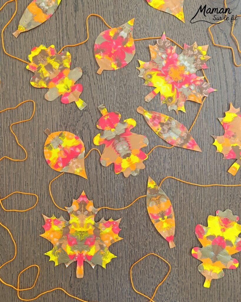 Créer une guirlande de feuilles mortes d'automne en peinture symétrique : activité créative, peinture et manuelle - Découpage des feuilles et peinture par symétrie en pliant le papier en deux - Technique de peinture pour aborder la symétrie - Couleurs chaudes et automnales - Scotchage à un fil ou à un bout de laine pour en faire une guirlande à suspendre, une suspension pour décorer - Bricolage et décoration DIY et facile - Bricolage Fait maison, décoration - Thème Forêts, Arbres, feuilles mortes, automne - Bricolage sympa et facile - Arts visuels Maternelle et cycle 2 - Maternelle et élémentaire - Créativité et lecture jeunesse - Cycle 1 ou 2 - tutoriel photos - mslf